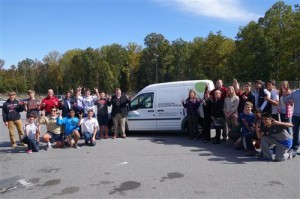 Lambert engineering students, Siemens representatives, Lambert faculty and staff, and FCS employees gather to welcome the all-electric van to the school.