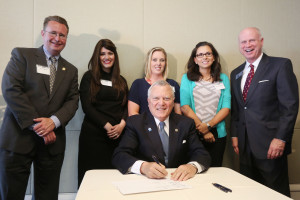 Gov. Deal signs HB 62 with Rep. Tanner (left)